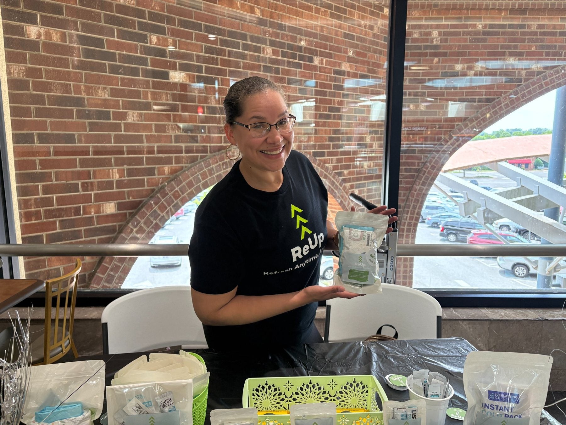 Founder of ReUp holding a personal care kit